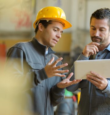 boss and worker checking results on the tablet